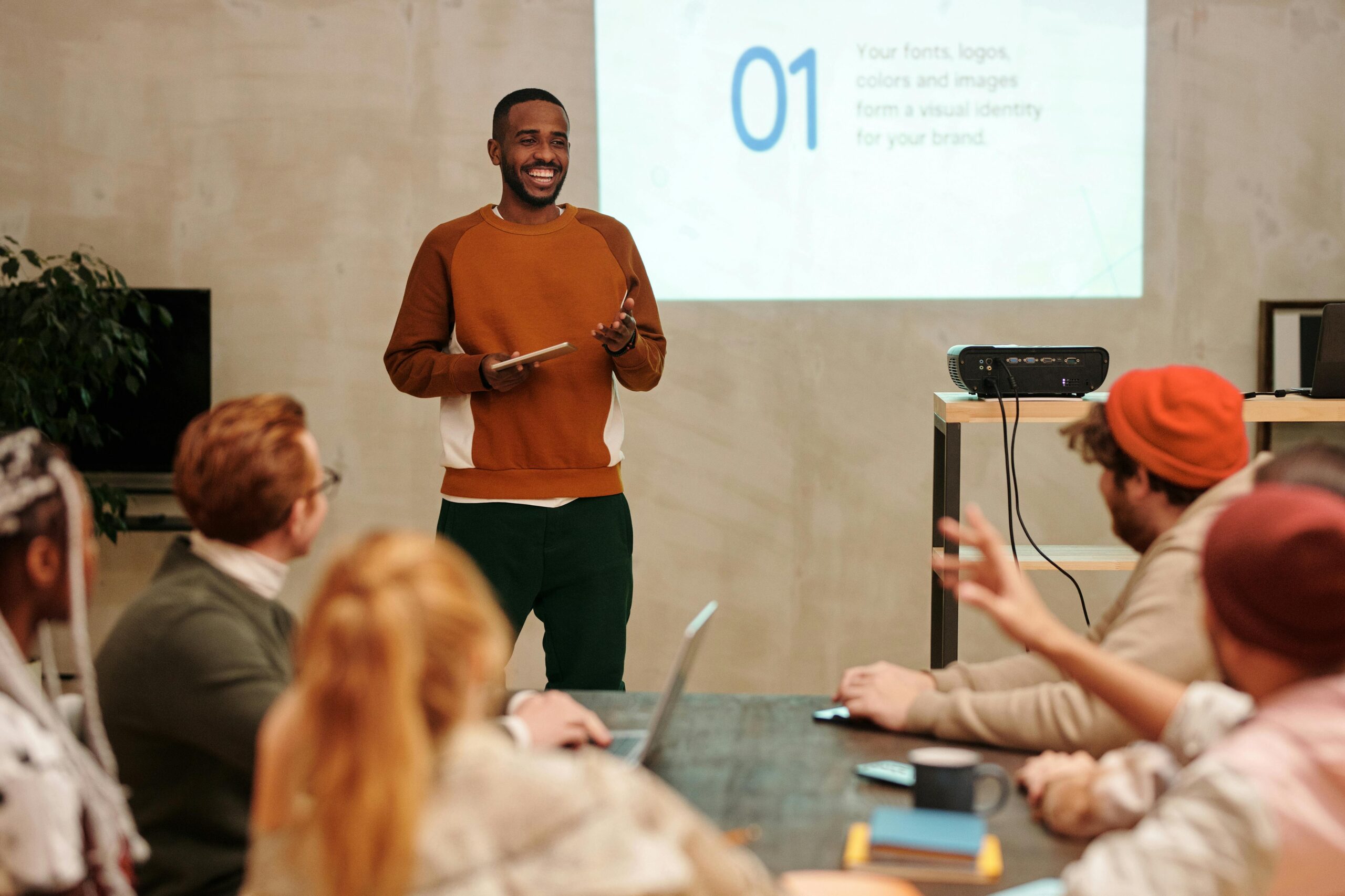 Man in Sweatshirt talking In Front of People